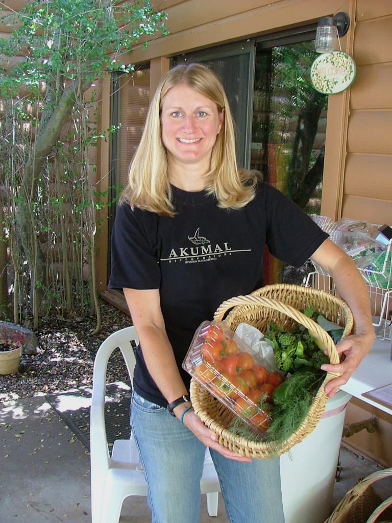Woman holding basket of organic produce